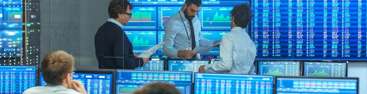 An office of traders with multiple trading screens